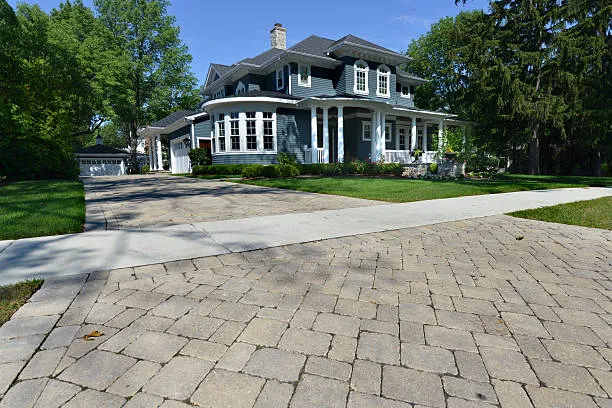 Established Austin home with a paver-style concrete driveway and mature landscaping