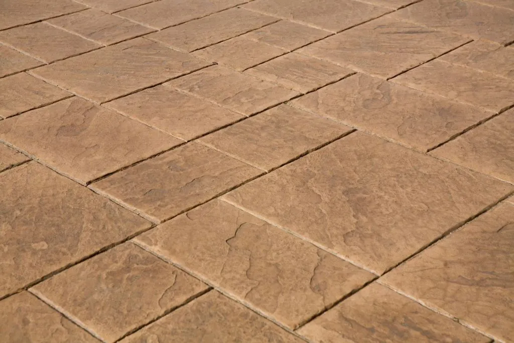 Slate-pattern stamped concrete with a warm brown finish in Austin, Texas